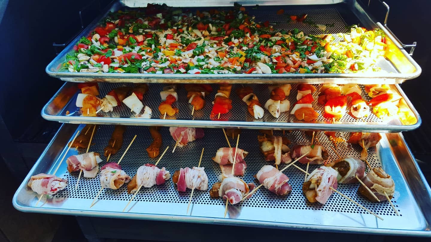 Colorful skewers and bacon-wrapped bites on a three-tier Bull Rack